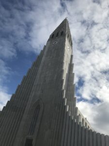 A 10-day Itinerary to Iceland's Ring Road 2 Hallgrímskirkja Lutheran church in Reykjavik. The white church has turned gray with age and the elementrs. It stands tall in the blue sky and is surrounded by fluffy clouds
