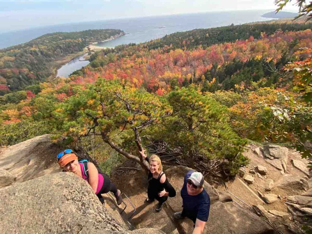 A view from the top of hikers just down below with Sand Bar in the distance.